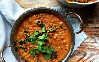 Creamy tomato and coconut dhal with cavolo nero